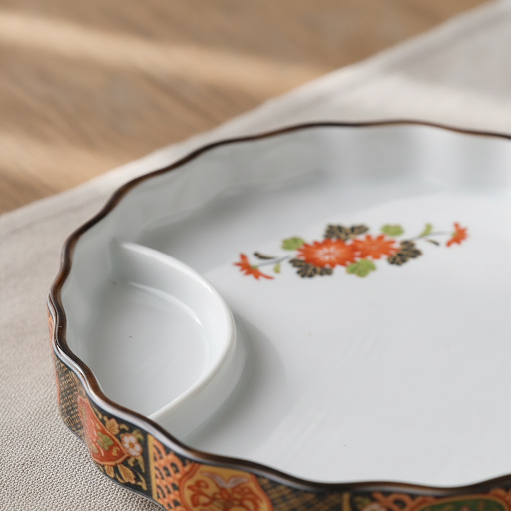 Close-up of glazed floral hand-painted detail and decorative rim on the ceramic plate