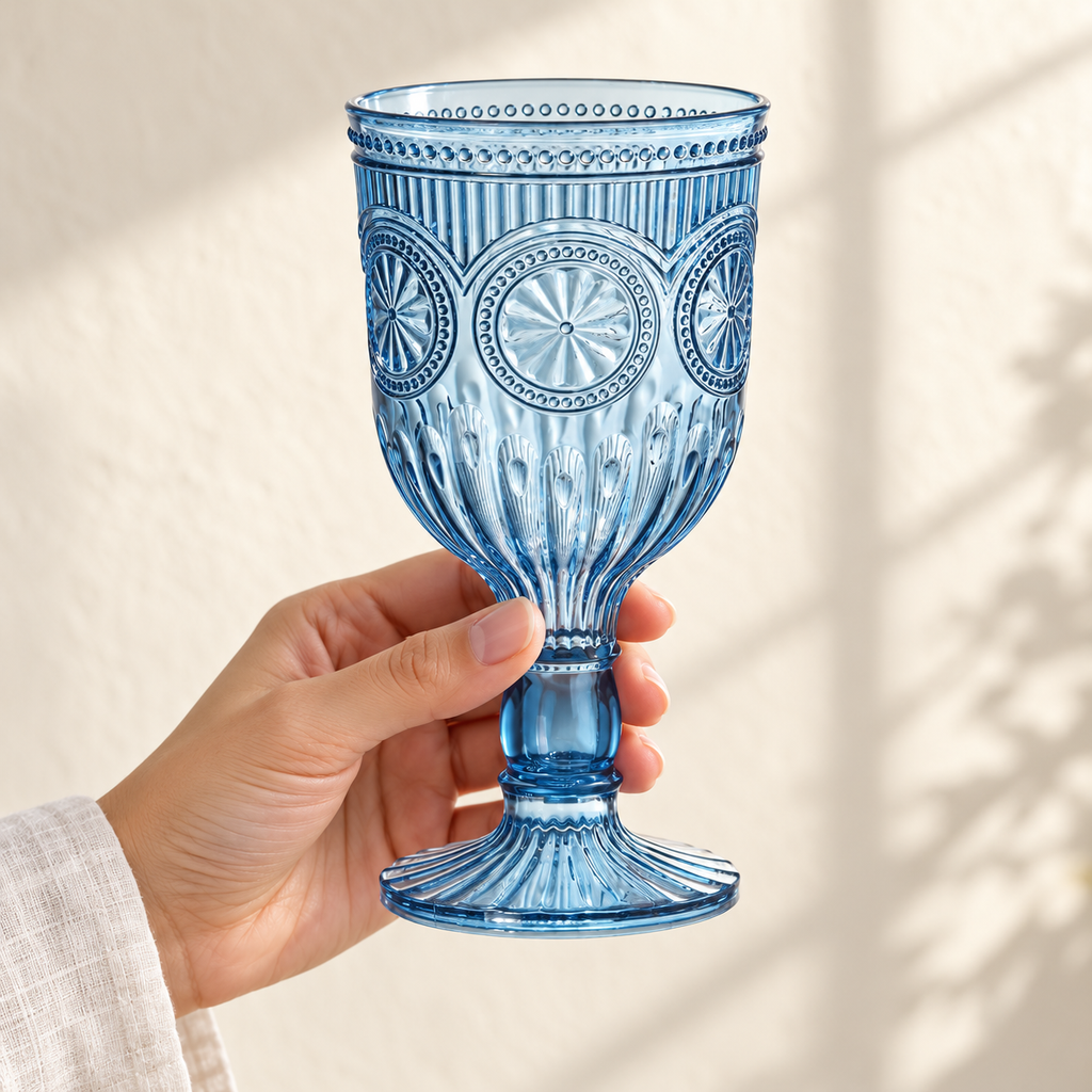 Smoky blue embossed plastic goblet held by an adult hand