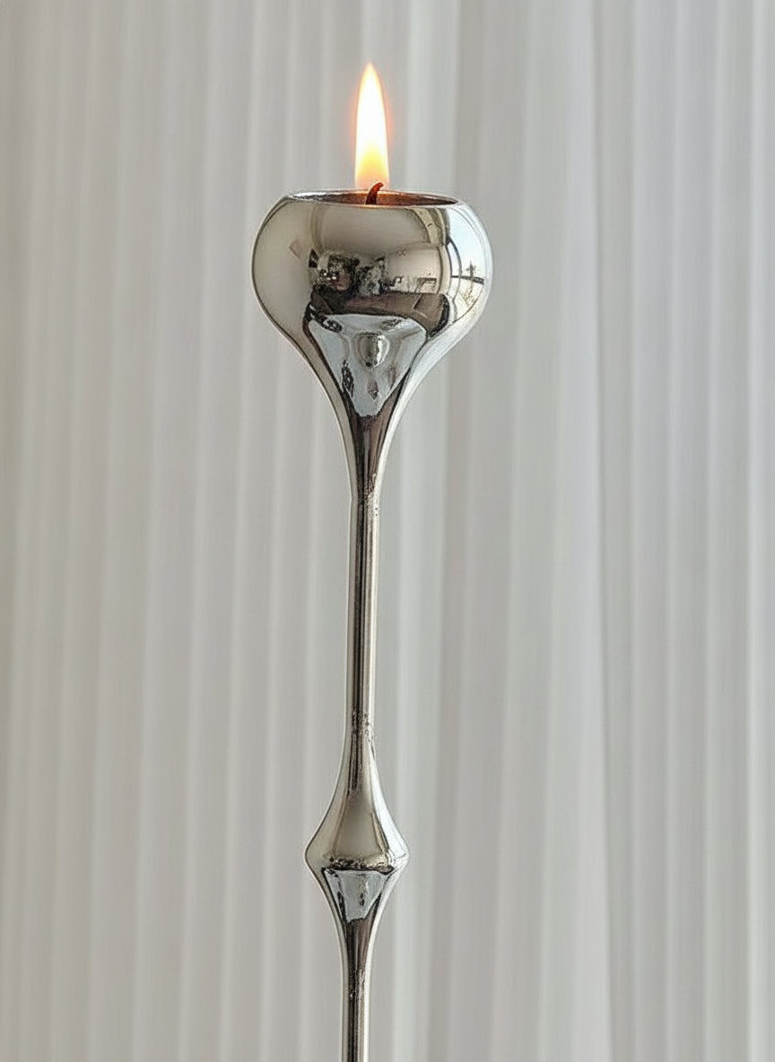 Macro close-up of the hand-polished candle cup, slim neck and faceted node of the teardrop candlestick
