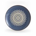 Slate-blue decorative ceramic wall plate with cream petal-burst medallion