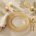 Clear gold-flecked-rim party plates with gold cutlery in an elegant wedding place setting