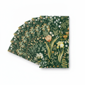 Fanned stack of vintage green botanical floral paper guest napkins on white