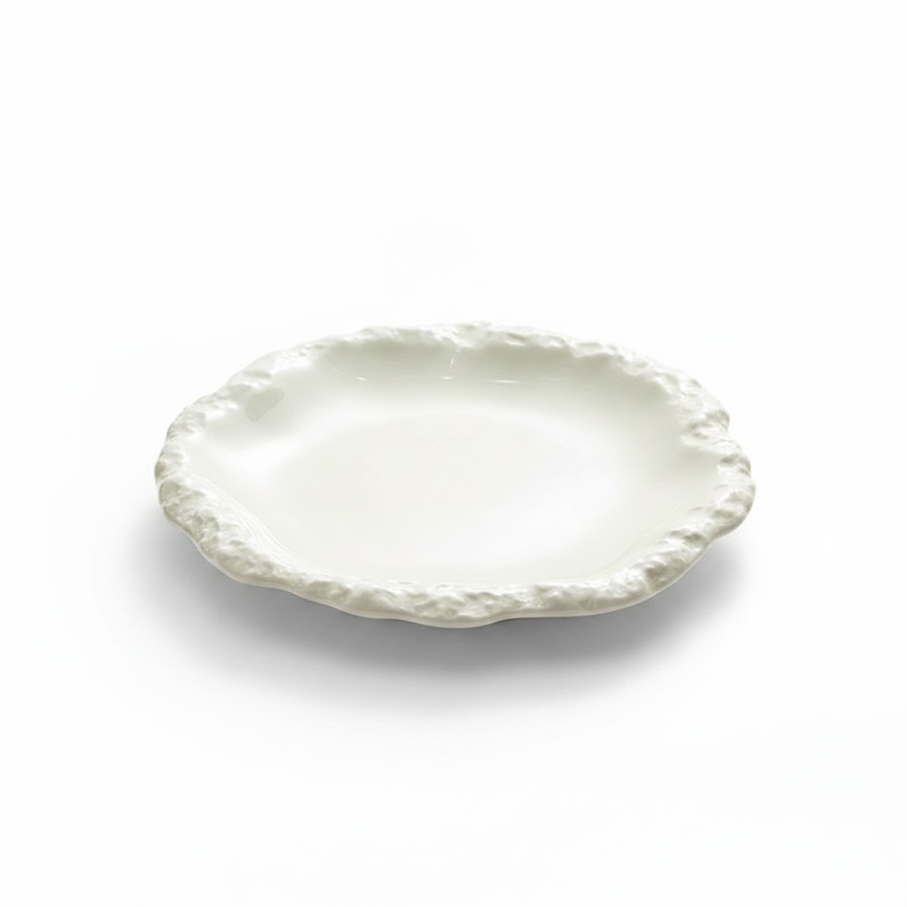 Crosta white glazed ceramic dinner plate with hand-pinched ruffled rim, studio white background