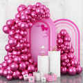 Chrome hot pink fuchsia balloon garland arch assembled against a soft white party wall