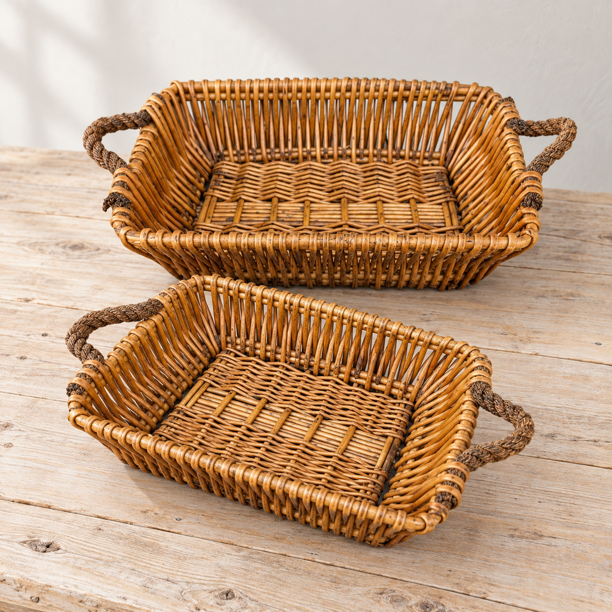 Two empty willow baskets on a wooden table.
