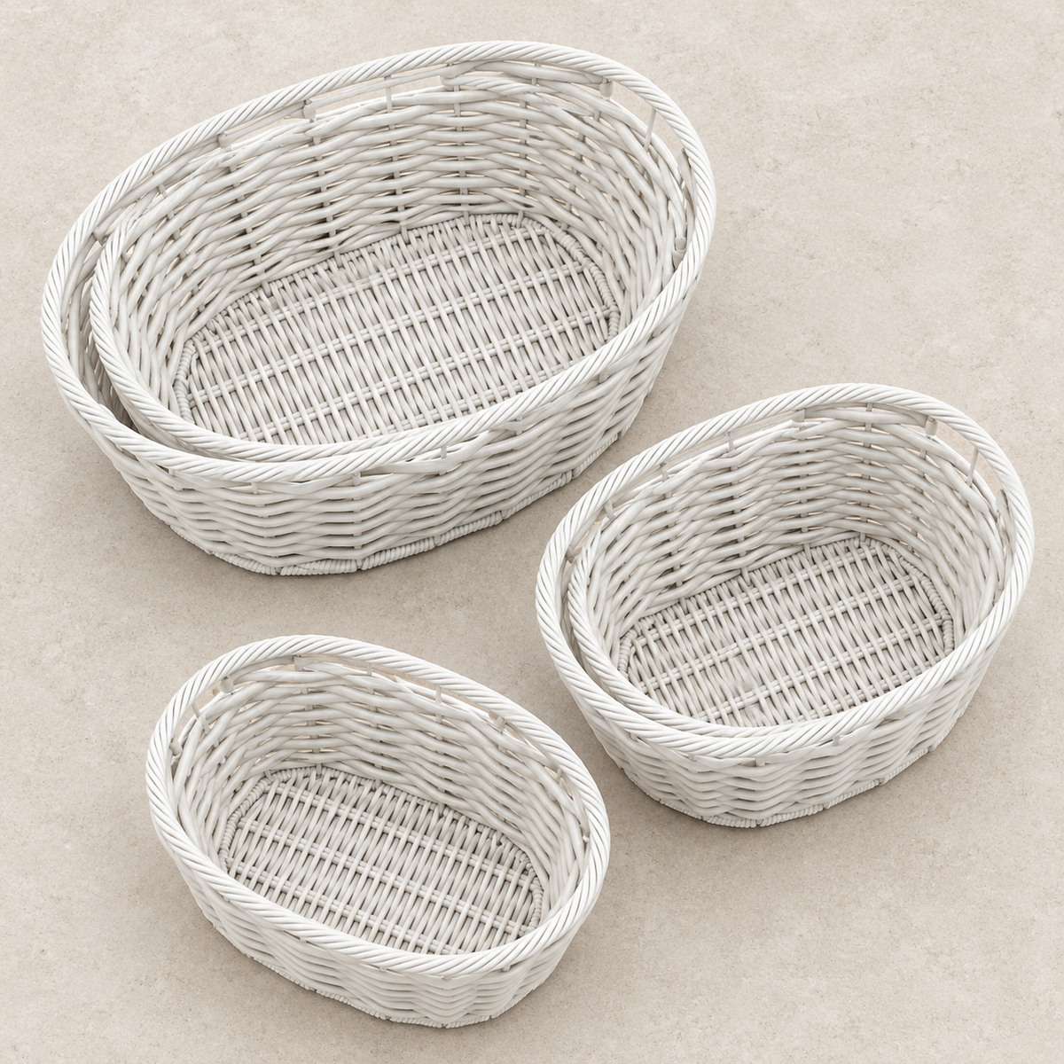 Three white baskets separated to show their interiors.