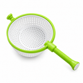 White and green colander on a white background.