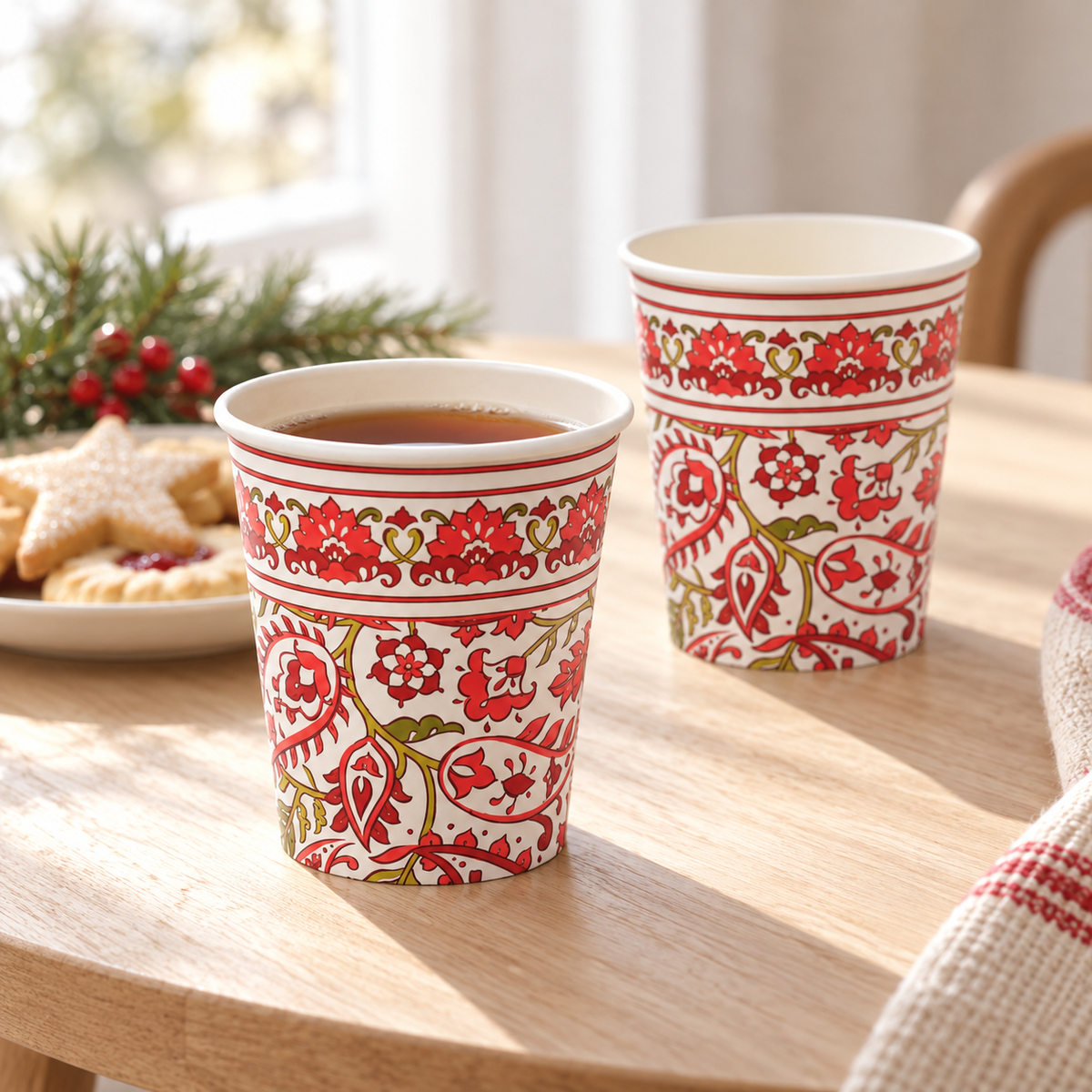 Two representative Festive Paisley paper cups on a drinks table; food and styling props are not included.