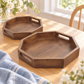 Two walnut-finish octagonal mango wood trays on a bright cream tabletop