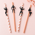 Representative rose-gold and striped paper straws with male dancer silhouette toppers; a sample of the designs, not the full pack. Glassware and styling are not included.