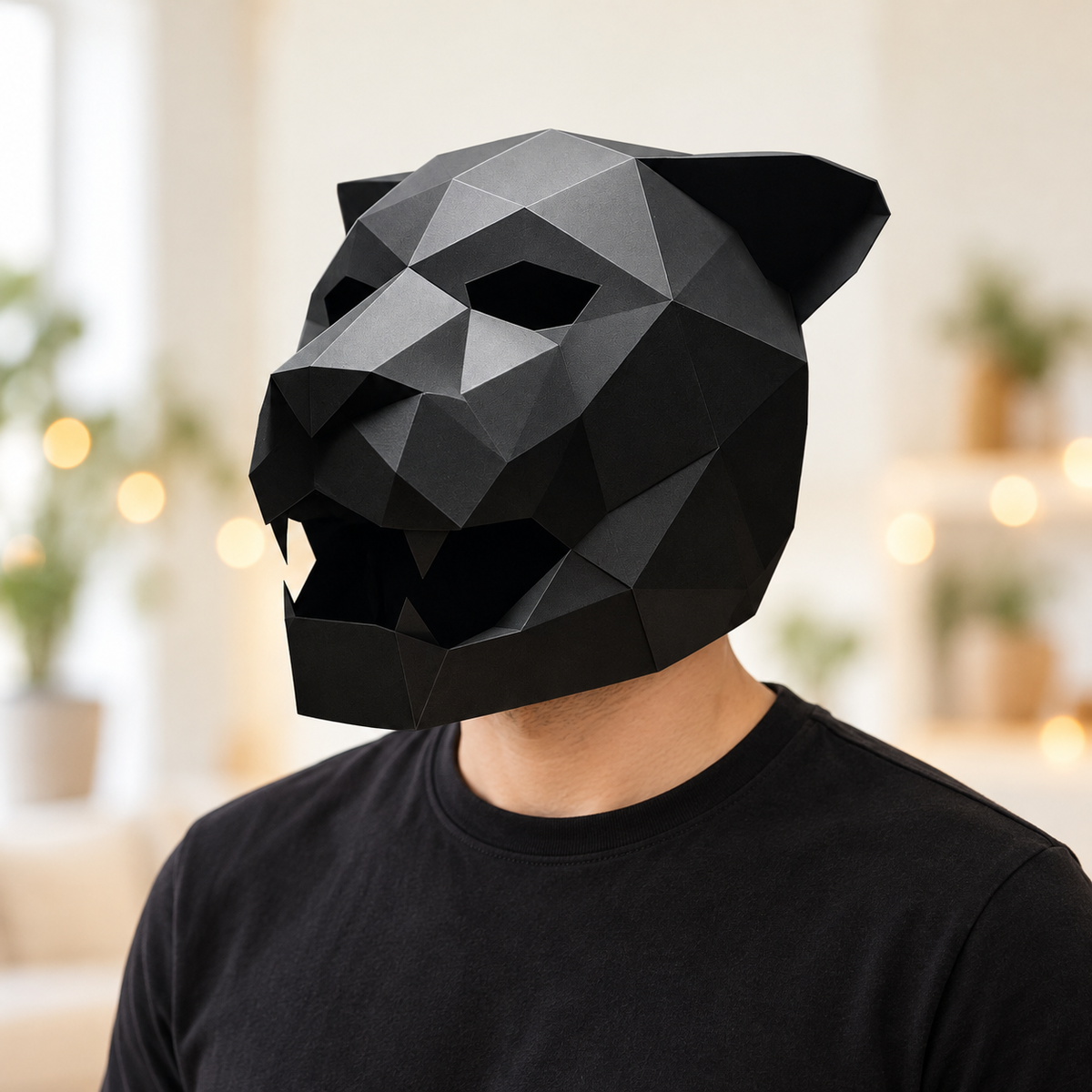 Adult wearing the black faceted animal mask in a bright room; clothing and styling props not included.