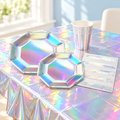 Representative iridescent birthday tableware display with octagonal plates, cups and napkin; not all set pieces shown. Styling props are not included.