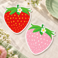 Two representative strawberry-shaped paper napkins from the 100-pack; plates, flowers and styling props are not included.