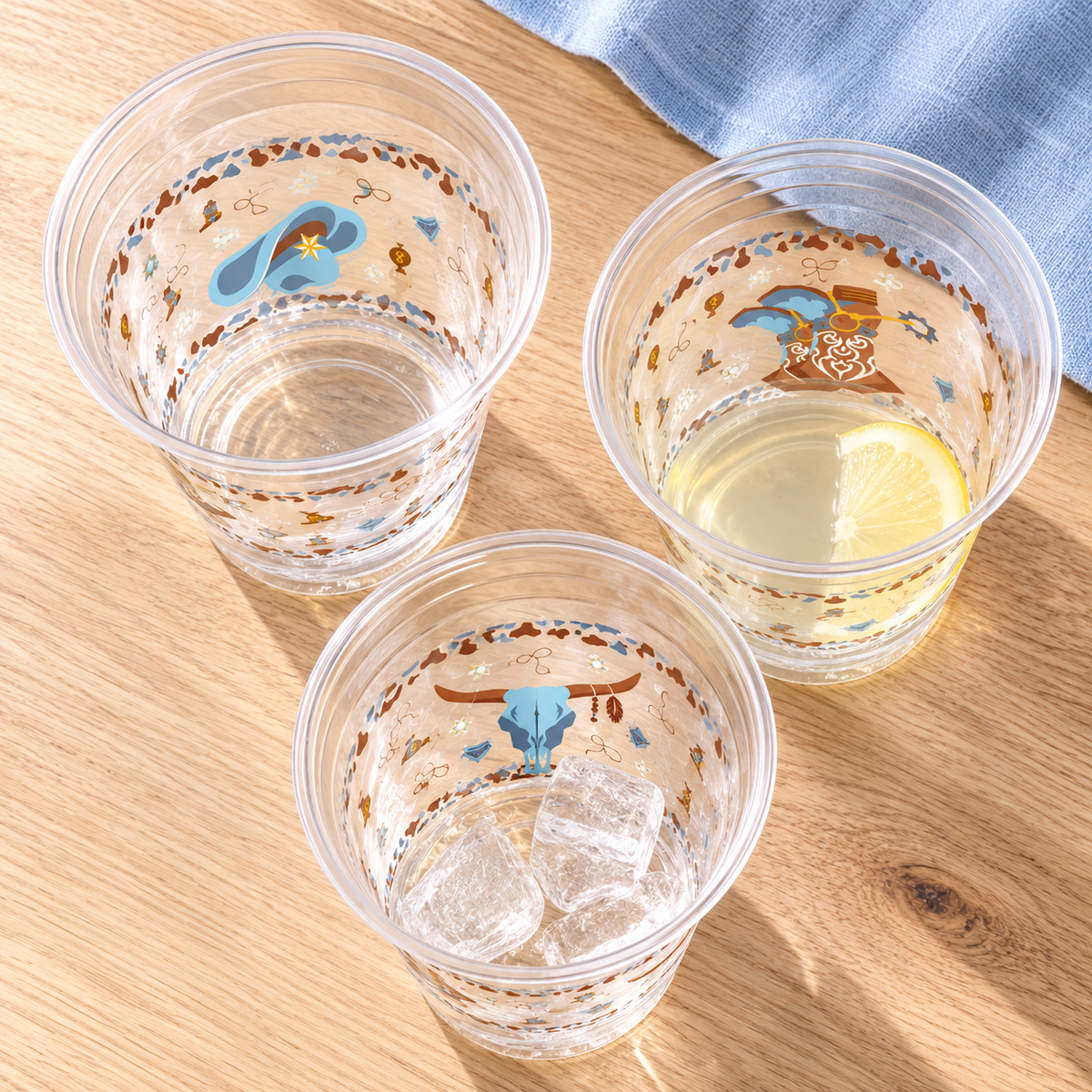 Overhead view of open clear Blue Cowboy cup rims; drinks, ice and linens are not included.