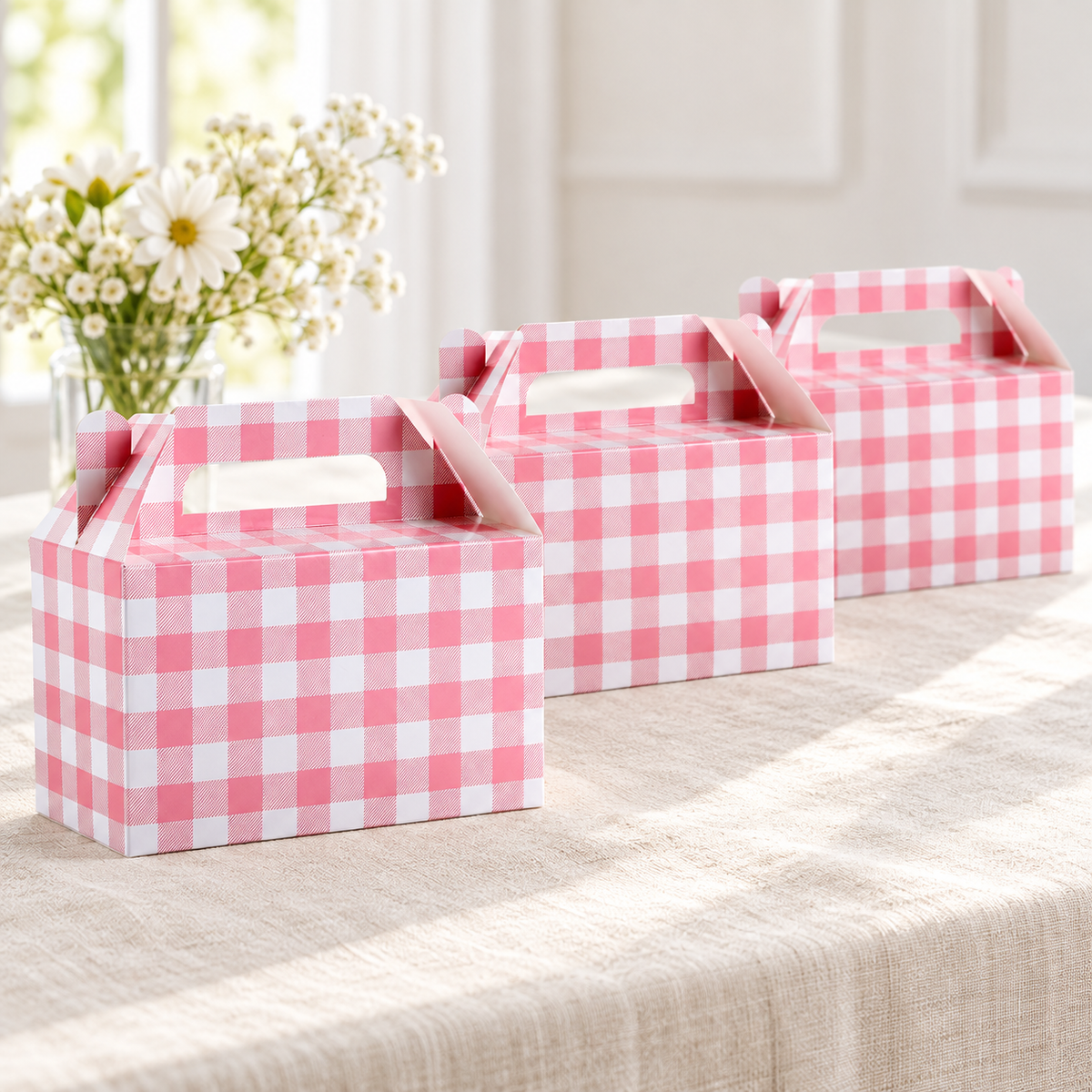 Pink gingham favor box, favor table view. Representative portion of the 12-pack; styling props are not included.