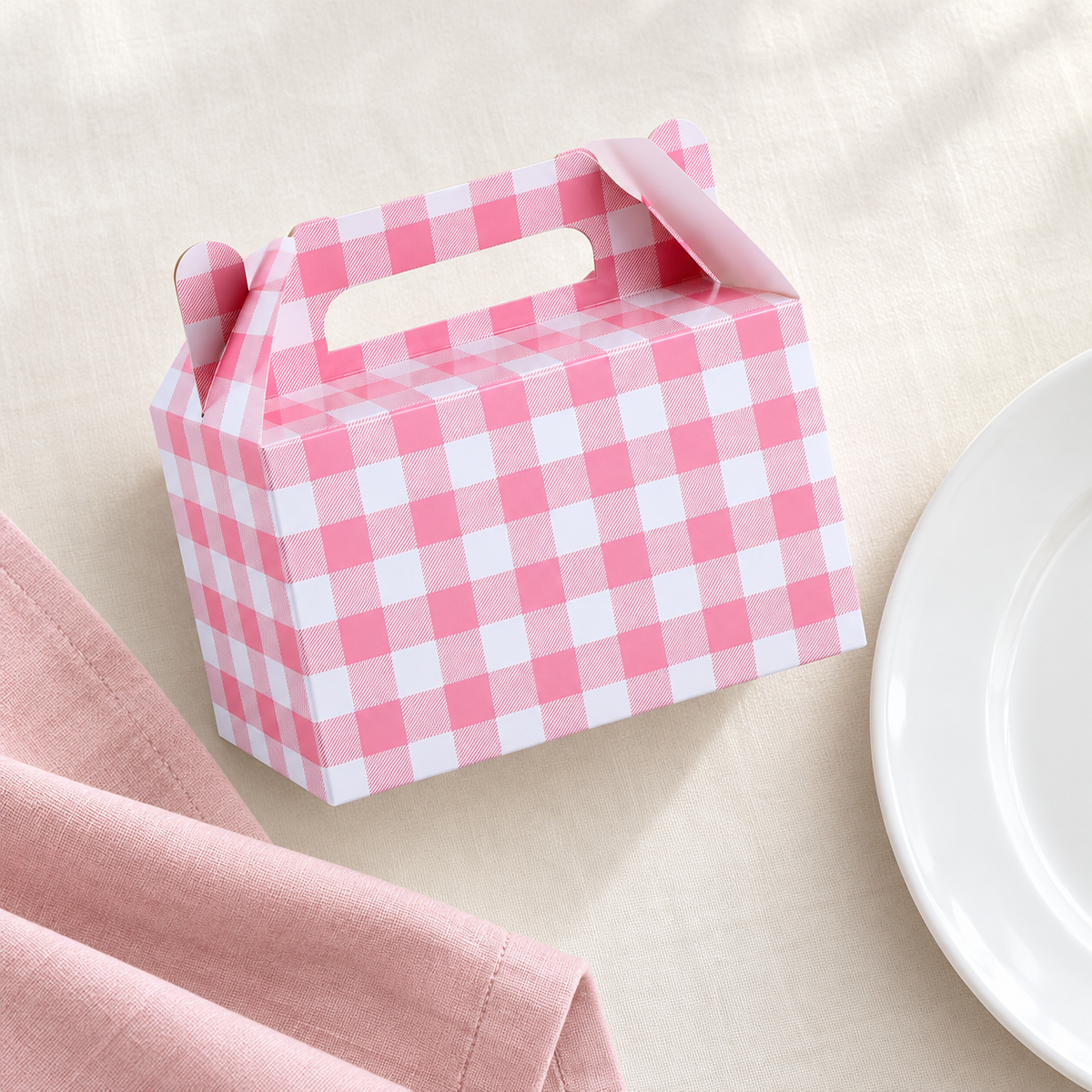 Pink gingham favor box, overhead view. Representative portion of the 12-pack; styling props are not included.