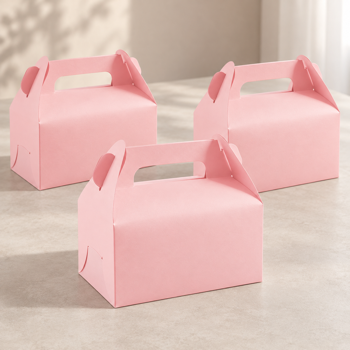 Three representative pink gable favor boxes from the 30-pack arranged on a tabletop.