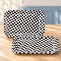 Two representative black-and-white race-flag paper trays from the 24-pack; not all trays shown.