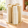 Gold four-compartment rotating cup organizer in a bright setting; cups and styling props are not included.