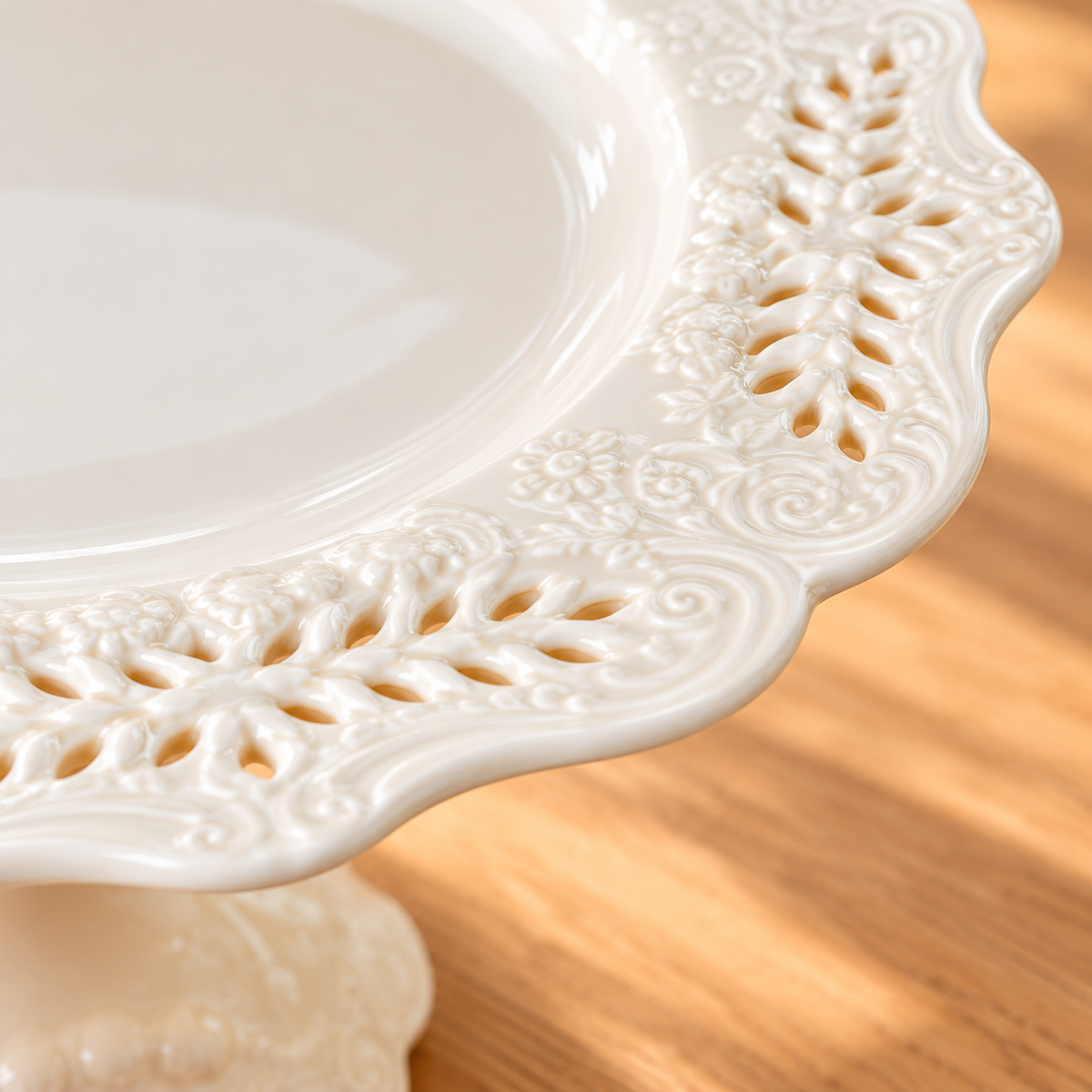 Close view of the lace rim and pedestal of the 10-inch ivory cake stand; the 8-inch option is not pictured.