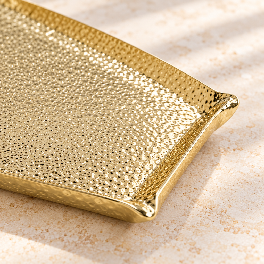 Close view of the gold hammered surface and corner of the Square Large serving tray; rectangular options are not pictured.