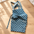 Blue polka-dot vest-style apron with contrasting straps and front pockets; styling accessories are not included.