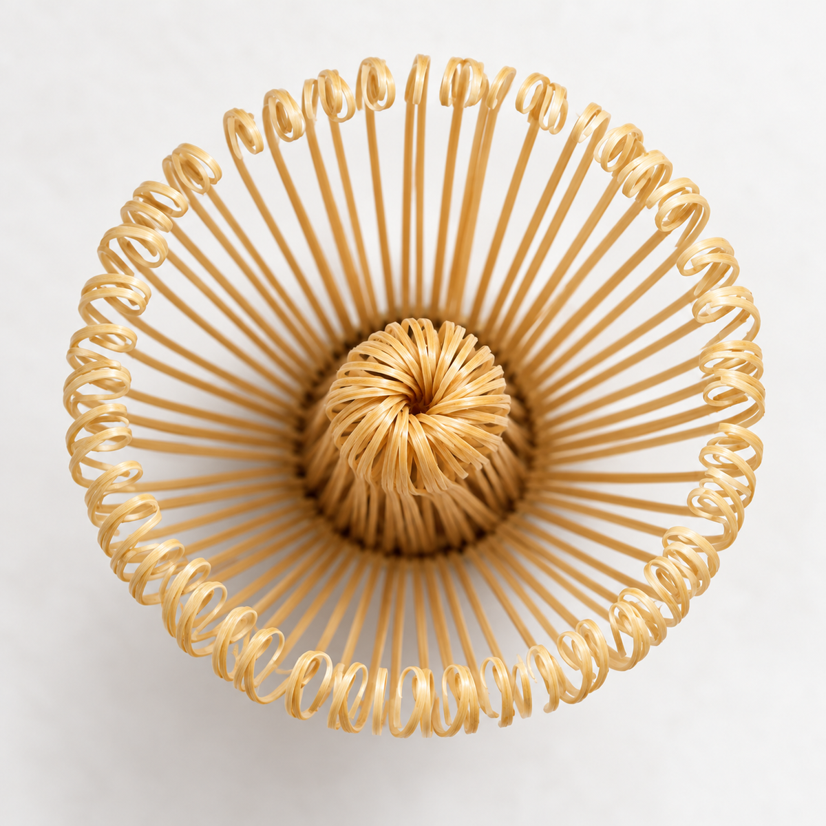 Overhead close view of the bamboo matcha whisk head and curved fine tines.