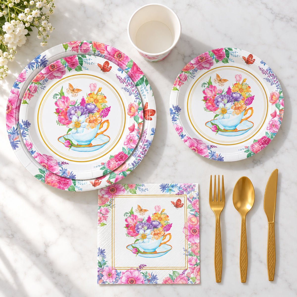 Overhead arrangement of floral tea-party plates and matching components; representative selection.