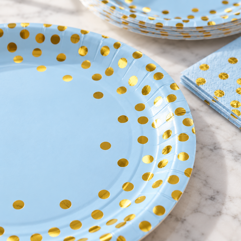 Close view of the printed gold-dot rim of a blue party plate.