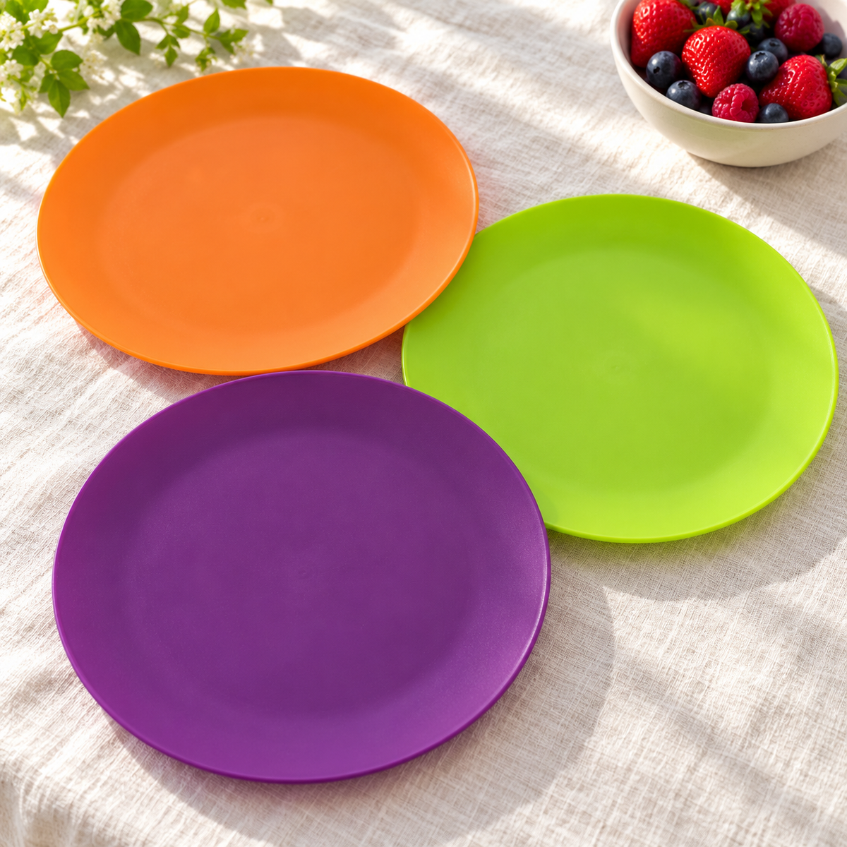 Orange, lime and purple plates arranged face up; representative selection from the 12-plate set.
