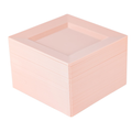 Pale blush-pink square plates stacked on white, showing the broad angular rim and shallow square well. Representative selection from the 100-plate pack.
