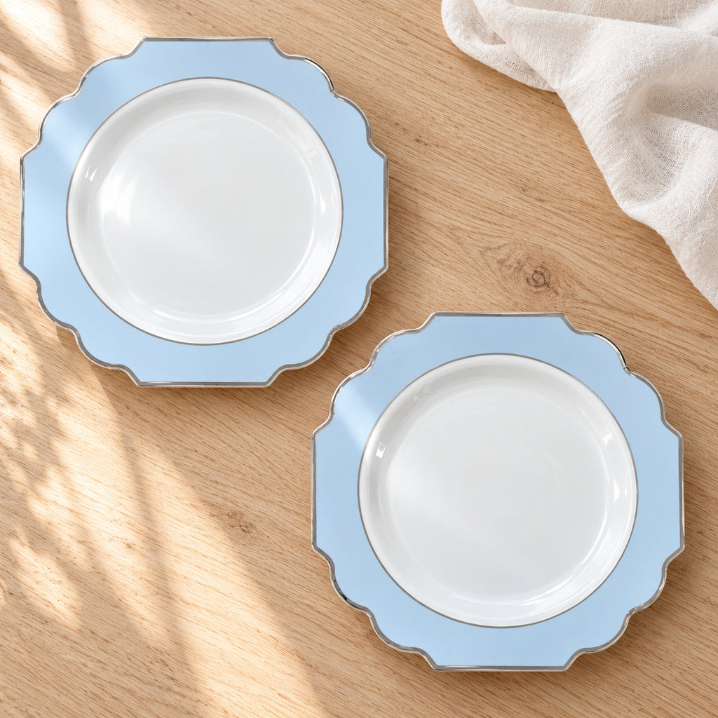 Two white and pale-blue ornamental appetizer plates with silver trim, photographed face-up on light wood. Representative selection from the pack; styling props not included.