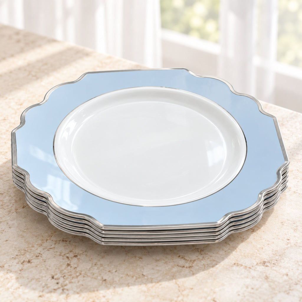 Short nested stack of white and pale-blue ornamental appetizer plates, showing thin silver edges and the top plate face. Representative selection from the pack; styling props not included.