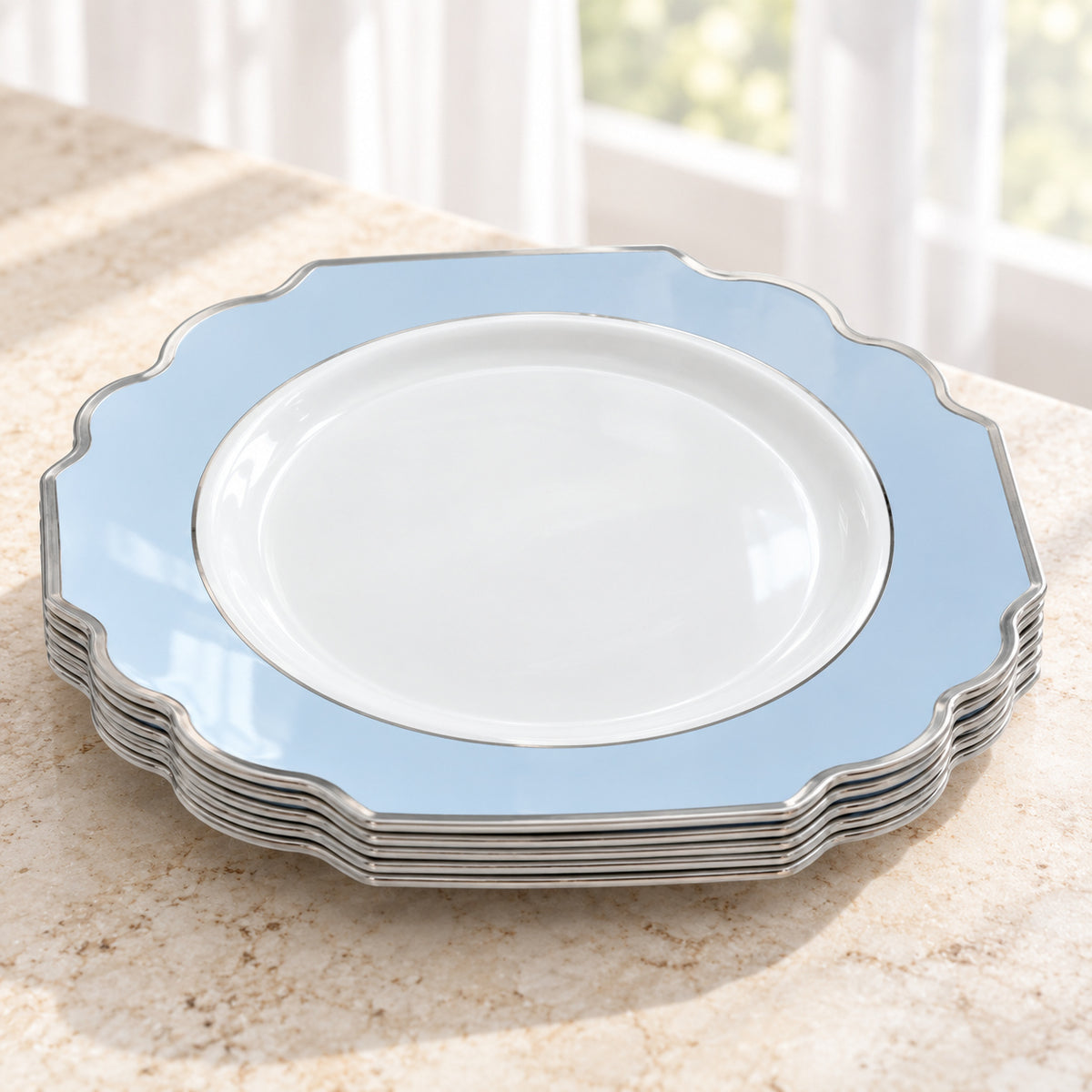 Short nested stack of white and pale-blue ornamental appetizer plates, showing thin silver edges and the top plate face. Representative selection from the pack; styling props not included.