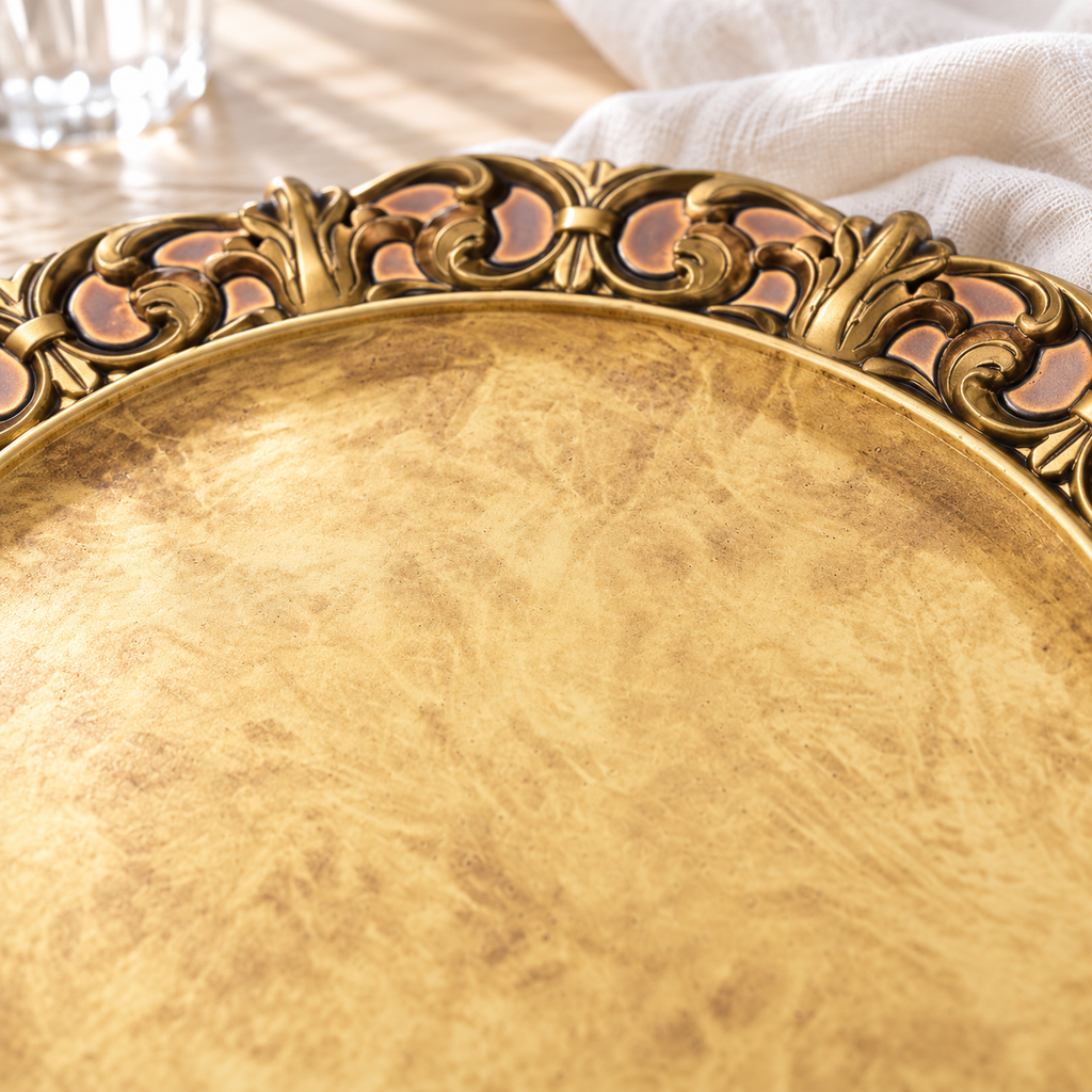 Detail of the charger’s mottled antique gold center and raised circular inner edge, with part of the embossed rim behind it.