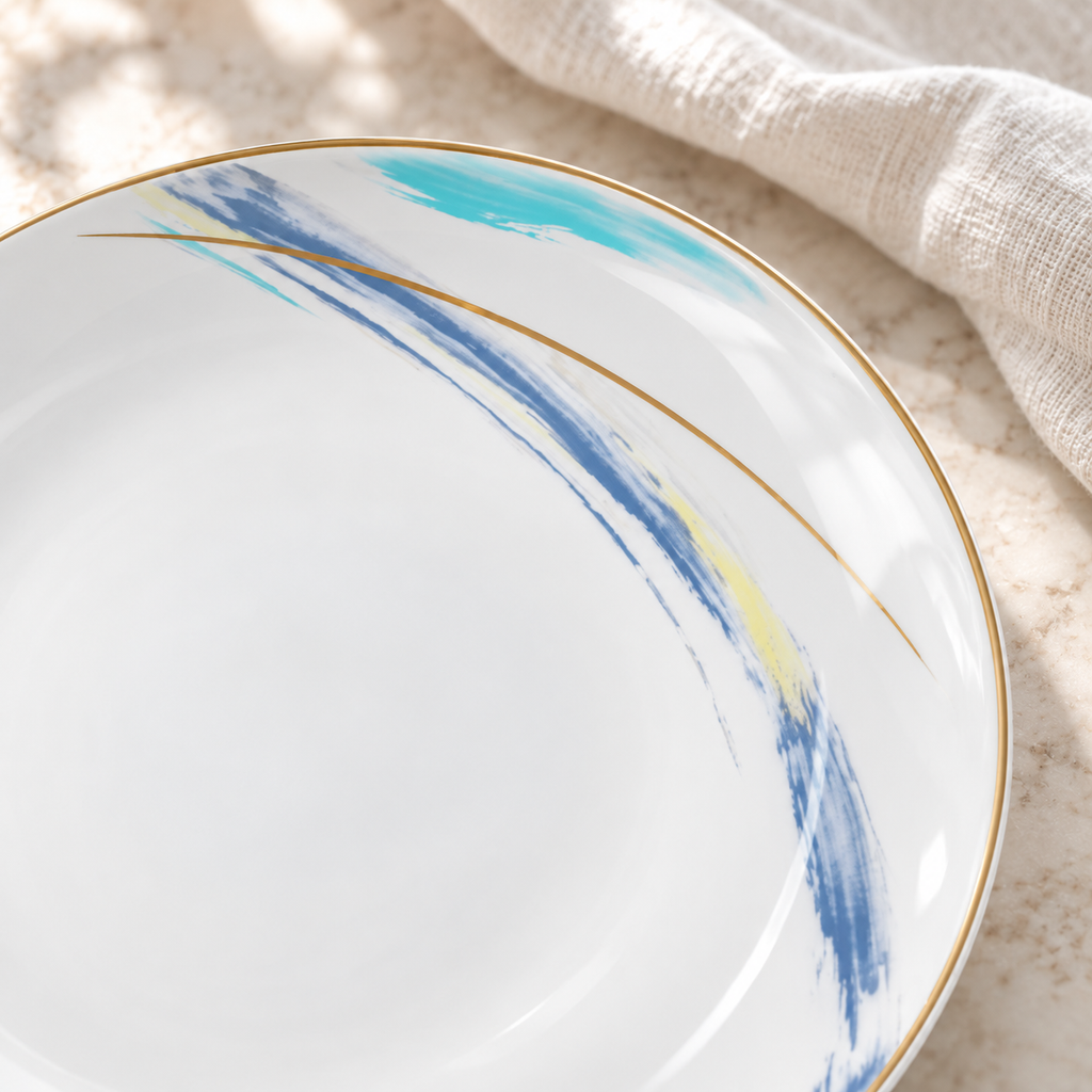 Close view of the localized blue, turquoise and gold decoration and thin gold rim on a Gilded Edge ceramic plate.