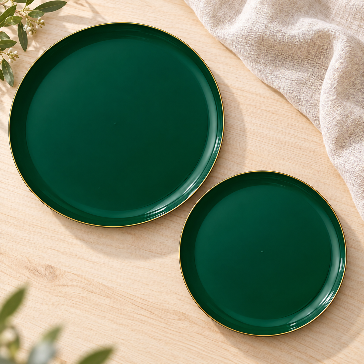 Two emerald green plates in different sizes face up on pale wood. Representative selection from the pack; styling props not included.