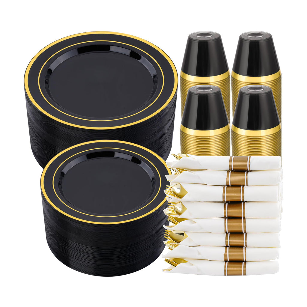Black and gold two-ring plate stacks, dark gold-rim cup stacks and white-and-gold wrapped cutlery on white. Representative arrangement; styling props not included.