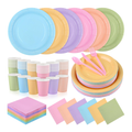 Pastel rainbow paper partyware assortment with six colors, two paper plate sizes, paper cups, folded napkins and pink plastic cutlery.