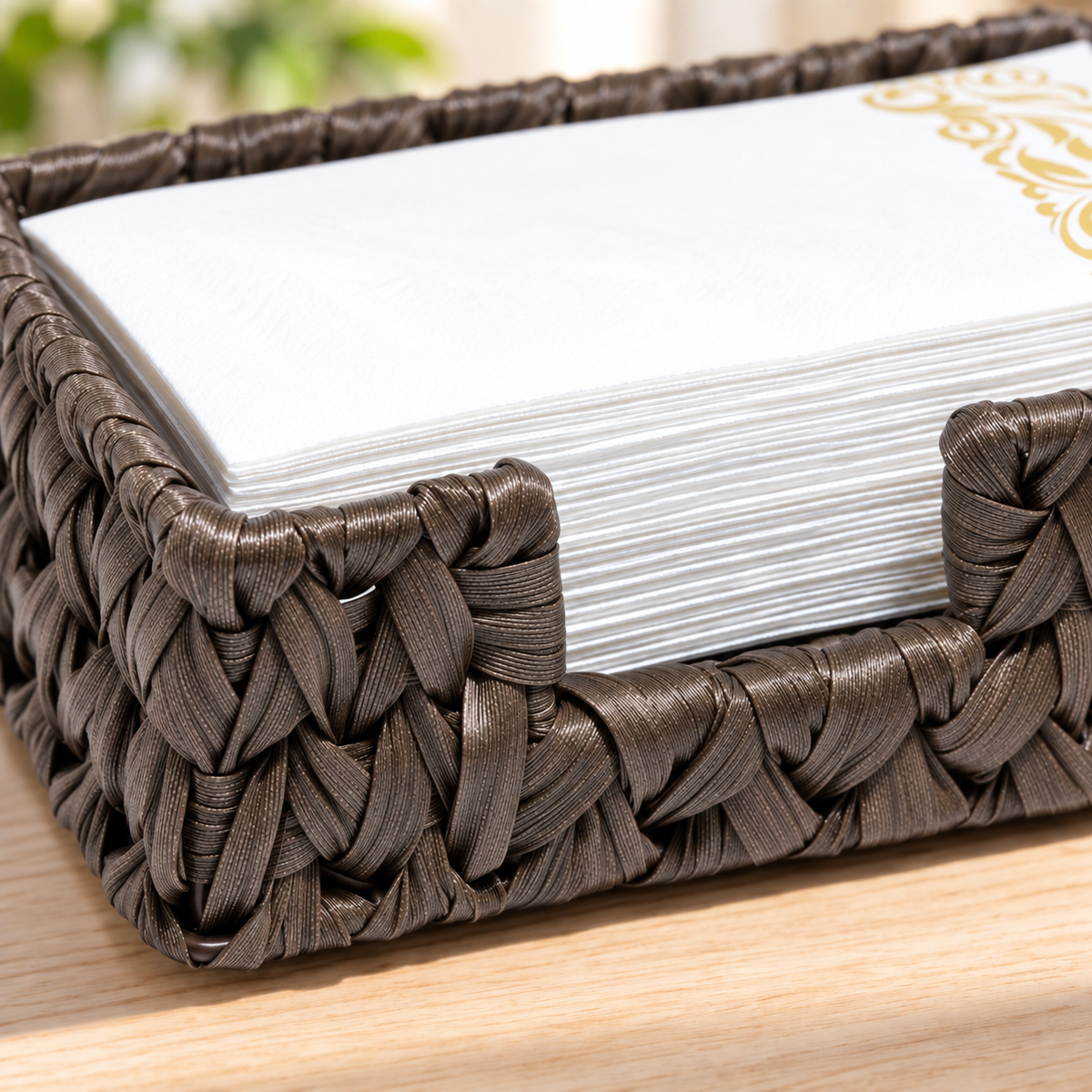 Close detail of the Bark Brown plastic-wicker tray's lowered front access notch, wrapped rim and broad ribbon weave, with layered guest towels shown as props. Guest towels and styling props not included.