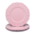 Pink decorative chargers with an embossed scalloped rim on white. Representative arrangement from the set.