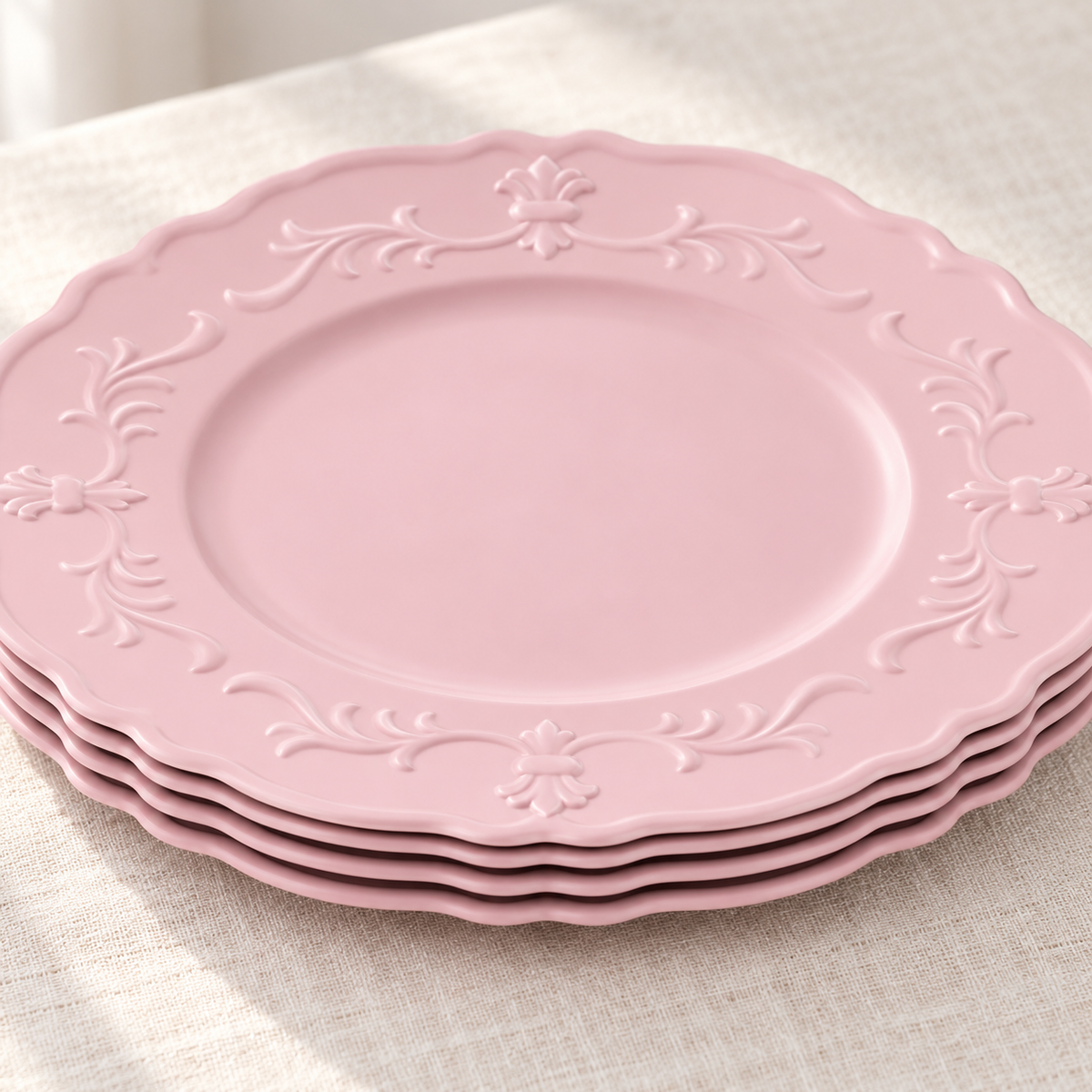 Close view of nested pink chargers and their scalloped edge profiles. Representative arrangement from the set.