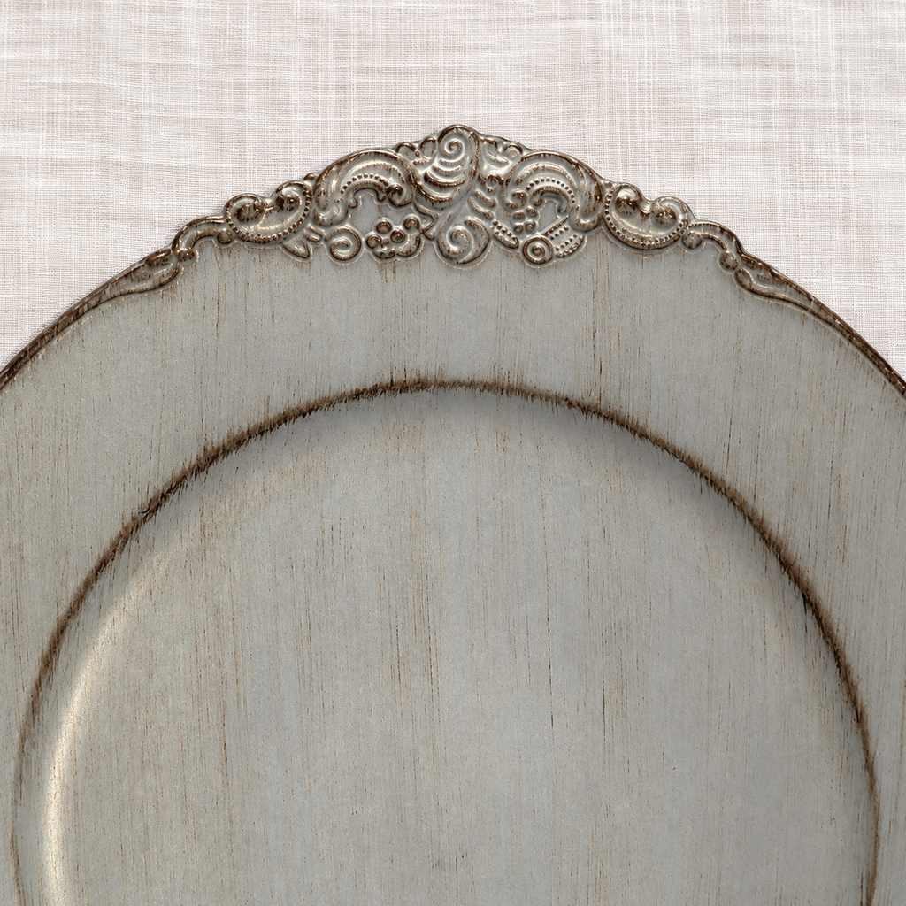 Moderate top-rim ornament detail showing antique grey decorative charger with distressed finish and ornate scroll rim.