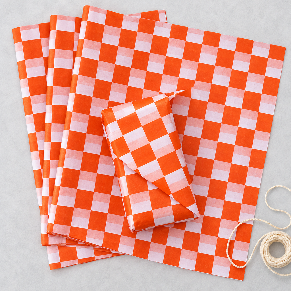 Vivid orange and white check tissue paper, overhead photograph, SKU B0D7VJJBM4. Representative sheets from 100-sheet pack; styling not included.