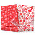 Heart print wax food wrapping paper in the two original red and white designs, white view. Representative sheets from 160 total; food, baskets and styling props are not included.