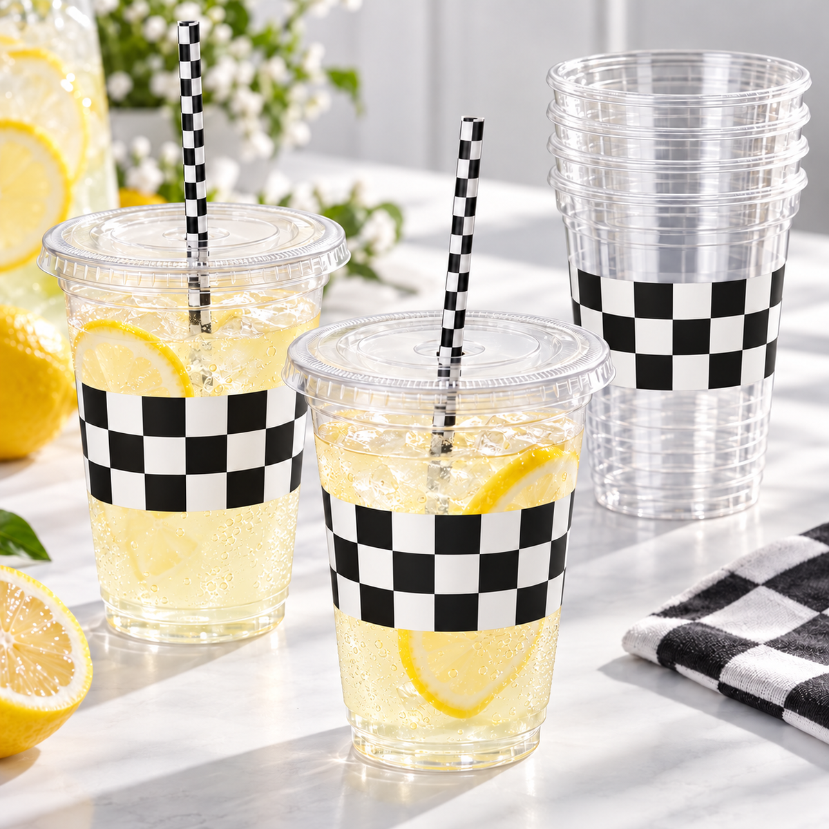Clear 16 oz checkered party cup with its flat clear lid and checked paper straw, station photograph. Representative items from 50 complete sets; drinks and styling props are not included.