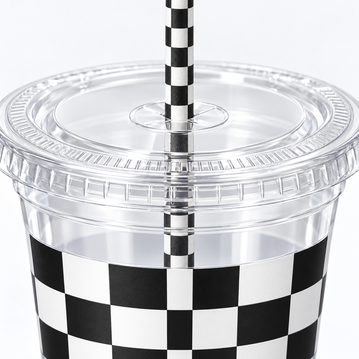 Clear 16 oz checkered party cup with its flat clear lid and checked paper straw, detail photograph. Representative items from 50 complete sets; drinks and styling props are not included.