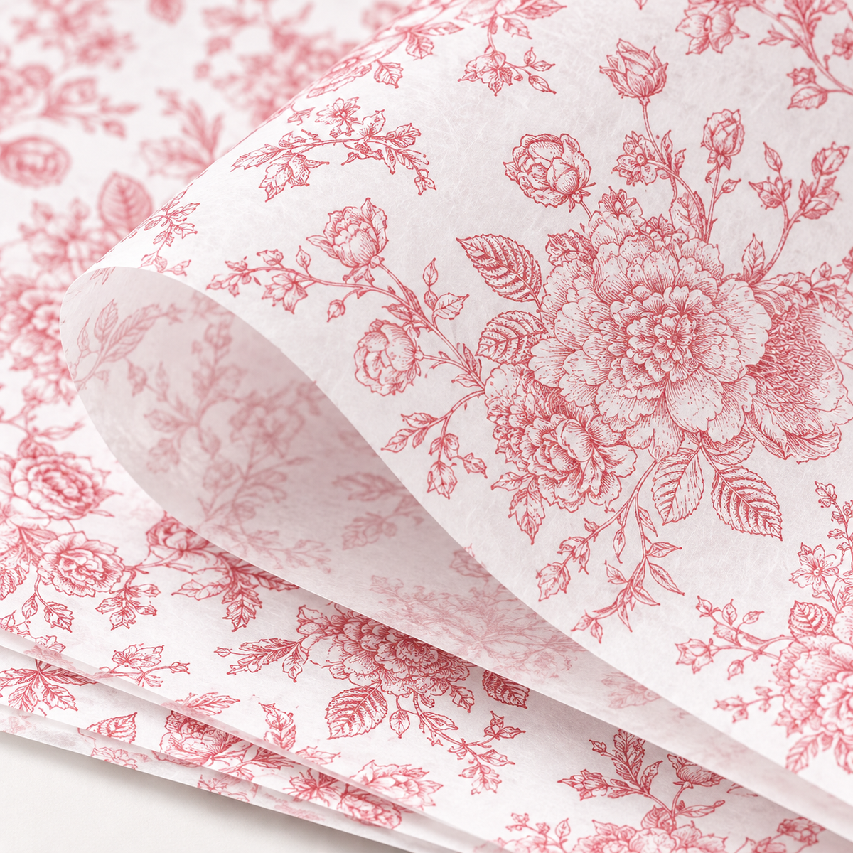 Rose gold floral printed tissue paper, detail view. Representative sheets from the 100-sheet pack. Gifts and styling props are not included.