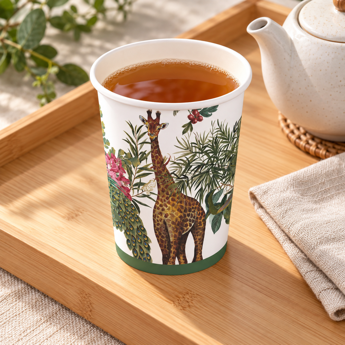 Giraffe and peacock botanical 12 oz paper cup, overhead photograph. Representative part of 20 cups; drink and styling props not included.