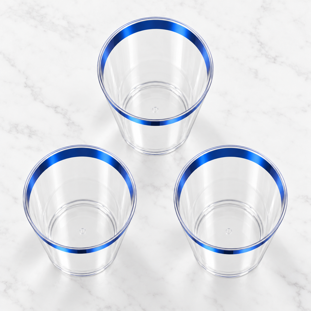 High-angle view into three empty clear tapered plastic tumblers with metallic blue rims.